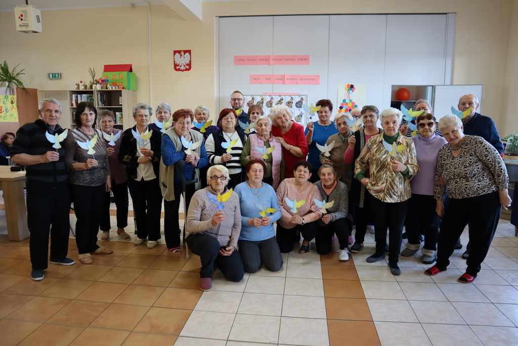 Seniorzy z własnoręczne wykonanymi Gołąbkami Pokoju