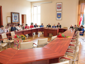 Jubilaci oraz ich rodziny w towarzystwie burmistrza Żnina siedzący przy stołach w auli w Urzędzie Mi