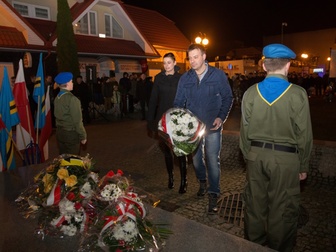 Przedstawiciele osiedla Cetniewo składają wiązankę kwiatów pod pomnikiem.